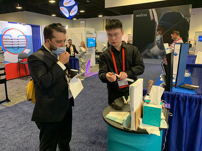 Visitors interacting with WellCare team at ASCRS